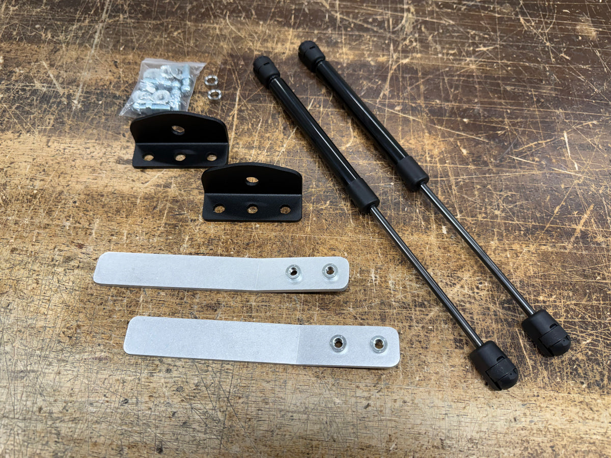Skillard hood strut kit for 1974–1978 Datsun 260Z and 280Z with two gas struts, mounting brackets, backing plates and hardware.
